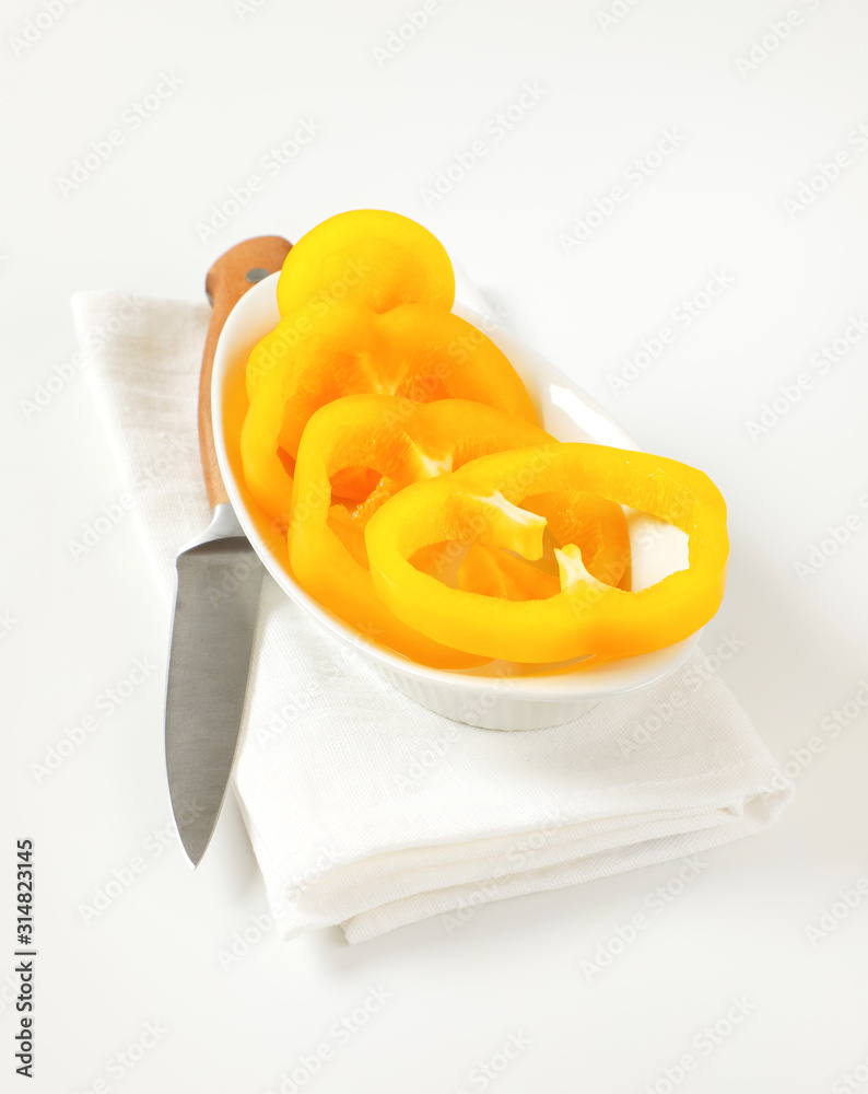 Yellow bell pepper slices in bowl Yellow bell pepper slices in bowl