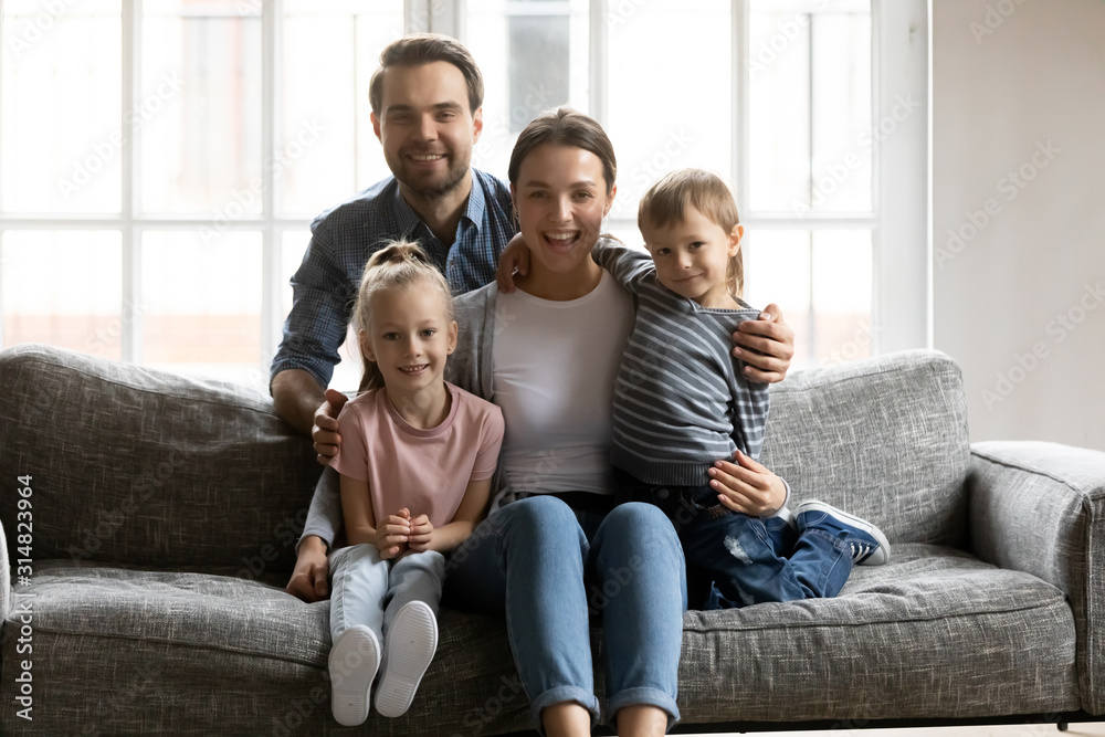 Portrait of happy family with kids relax on sofa Portrait of happy family with kids relax on sofa