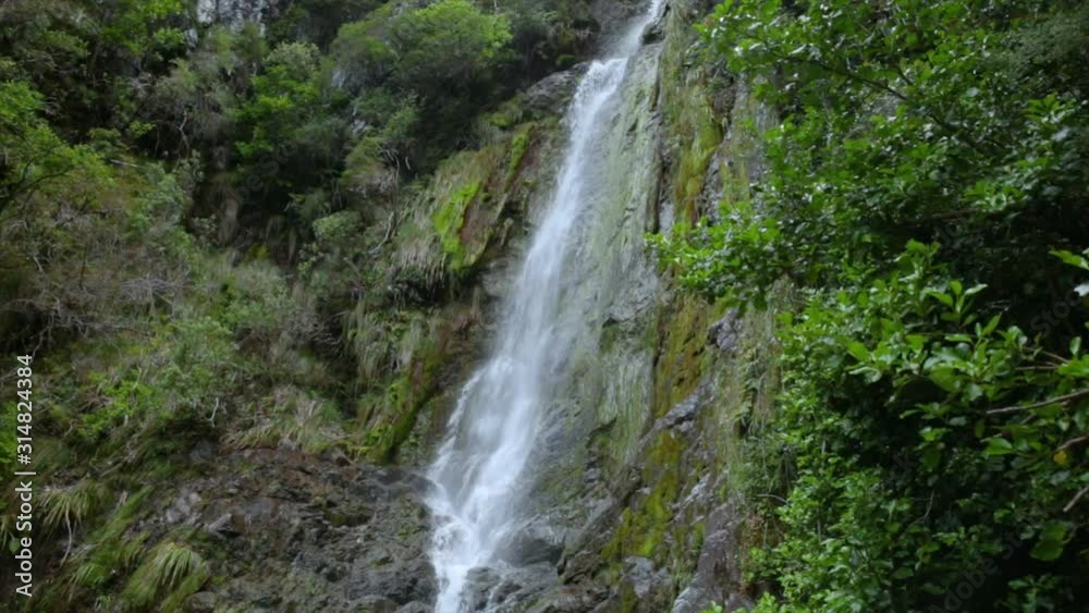 Waterfall in forest landscape. Fresh lush tropical rainforest foliage. Waterfall in forest landscape. Fresh lush tropical rainforest foliage.
