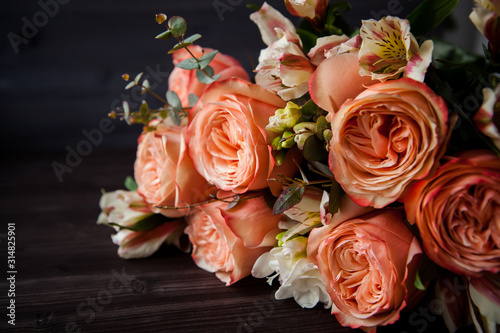 dark luxurious bouquet of gorgeous pink roses for Valentine's day on a dark wood background