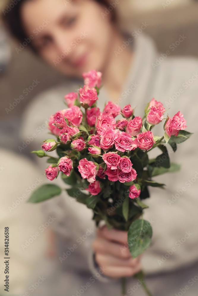 bouquet of bush of roses in female hands on a background bouquet of bush of roses in female hands on a background
