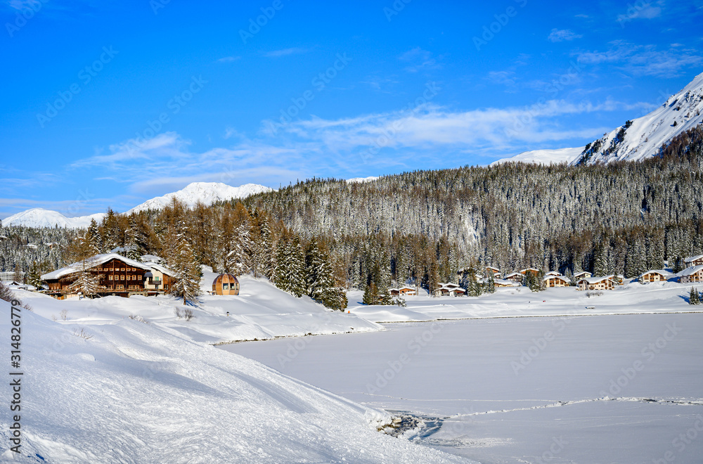 Landscape of lake Davos, covered by ice, in winter resort Davos, Switzerland.