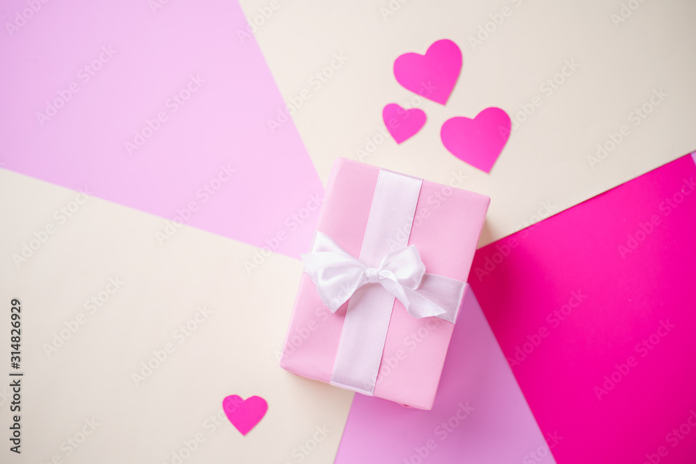 Valentine's, Mother's or Women's Day celebration. creative layout made of festive heart shaped decorations with gift box. holidays background concept