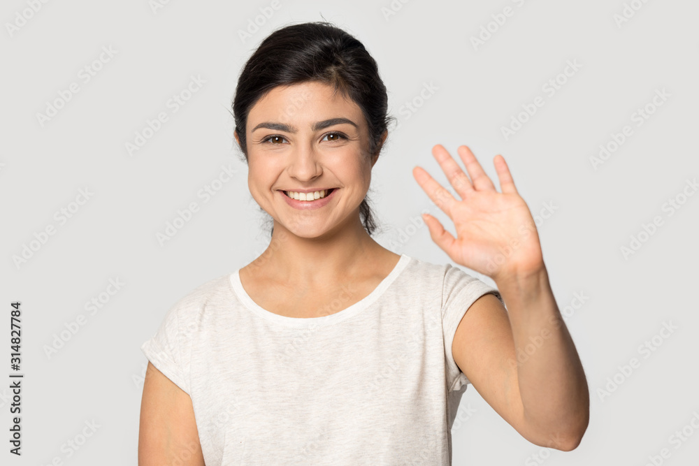 Pleasant young indian girl waving head shot portrait. Pleasant young indian girl waving head shot portrait.