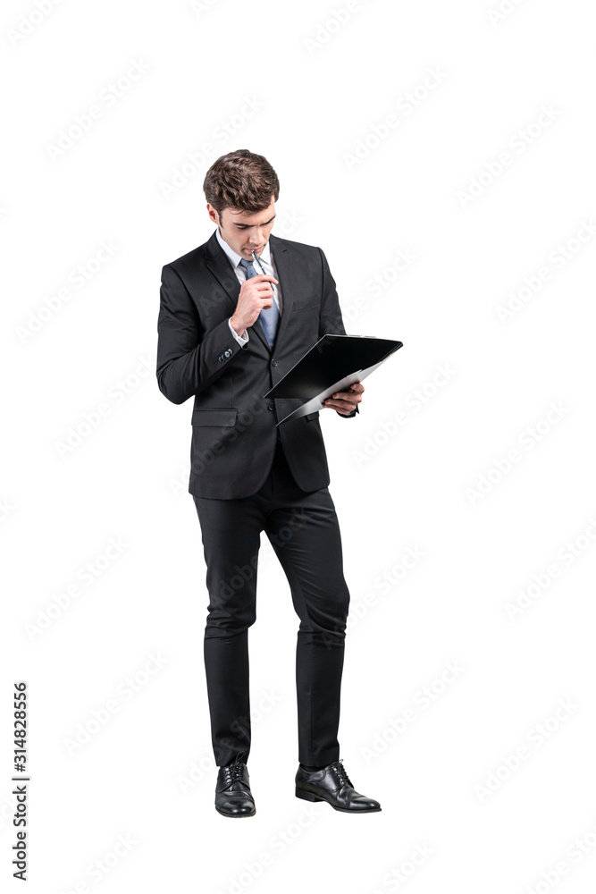 Thoughtful businessman with clipboard, full length Thoughtful businessman with clipboard, full length