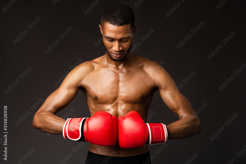 Handsome afro sportsman ready for fight at studio