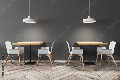 Square dining tables in gray cafe interior