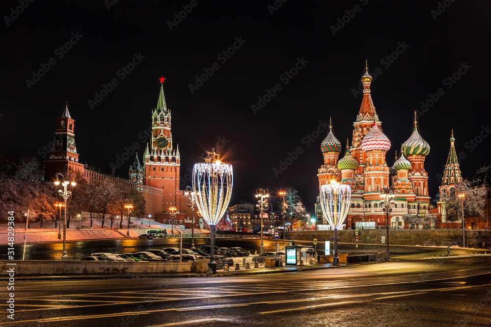 View from Moskvoretsky bridge to the Kremlin and Pokrovsky Cathedral on new year and Christmas holidays at night. Moscow, Russia