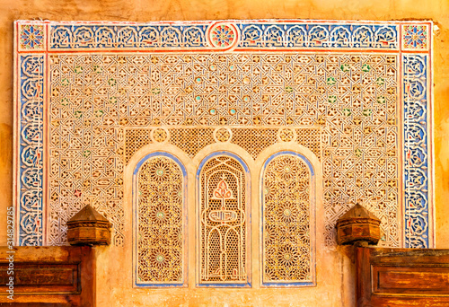 Detail of Islamic Mosque. It is an old architectural building in the middle of the Moroccan city. There are red bricks.