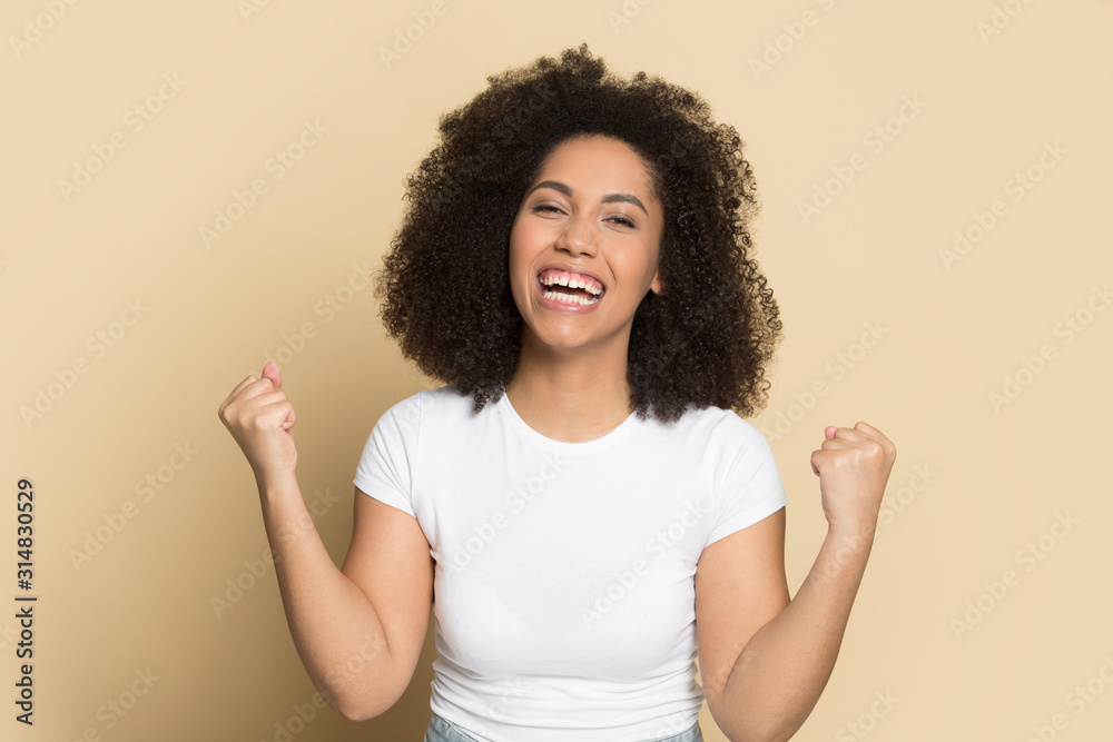 Euphoric laughing happy african american young lady making yes gesture. Euphoric laughing happy african american young lady making yes gesture.