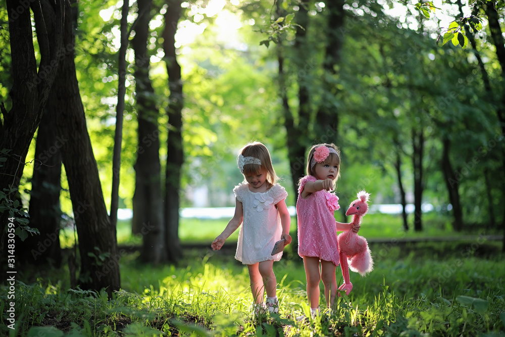 Fototapeta premium Mom with two daughters twins