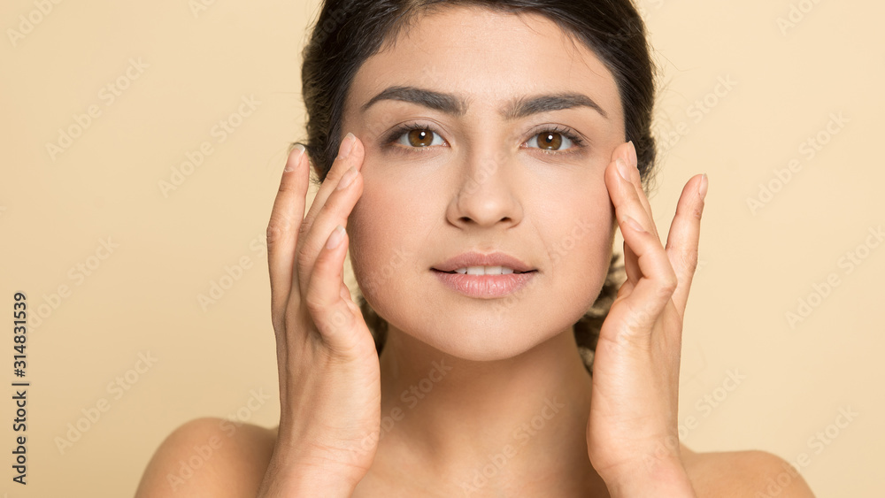 Indian ethnic lady with perfect skin touching area near eyes. Indian ethnic lady with perfect skin touching area near eyes.