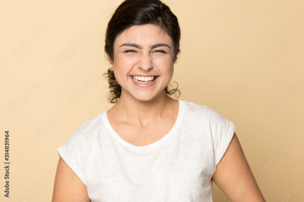 Indian ethnicity millennial lady laughing at joke, having fun. Indian ethnicity millennial lady laughing at joke, having fun.