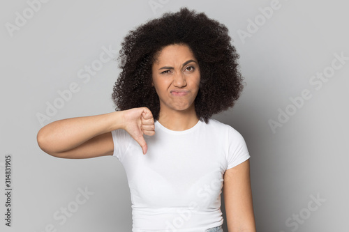 African american frowning female client showing thumbs down gesture.