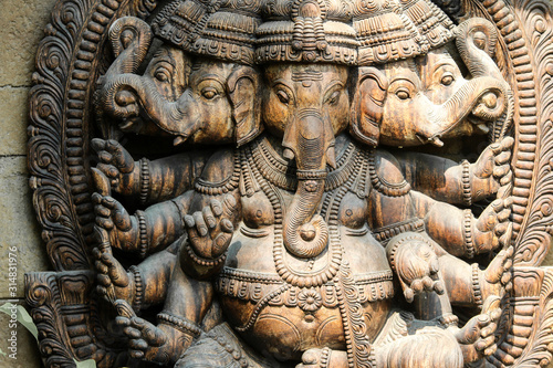 The detail of the wooden statue of Ganesha, one of the indian Gods in a public park. 