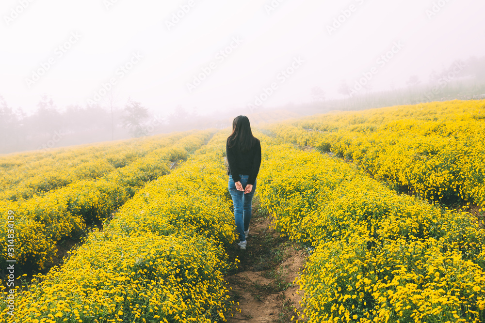 Traveler woman in flower garden Traveler woman in flower garden