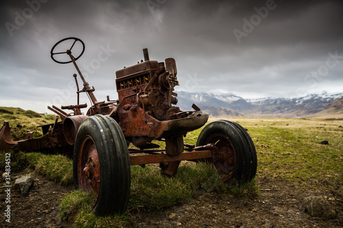 Old rusted abandoned tractor on a farm 