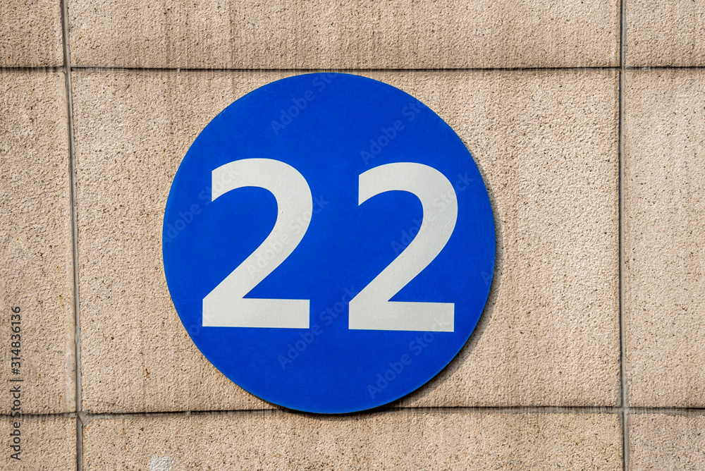 Sign with the number 22 hanging on the wall Sign with the number 22 hanging on the wall
