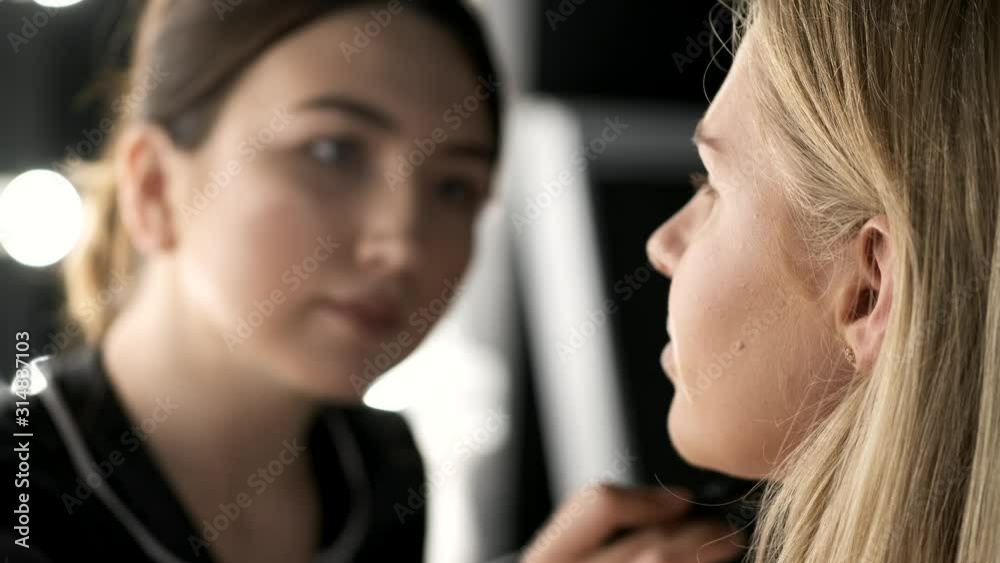 A girl is in a salon. She is getting ready for the party. The client has expressive facial features. A girl is in a salon. She is getting ready for the party. The client has expressive facial features.