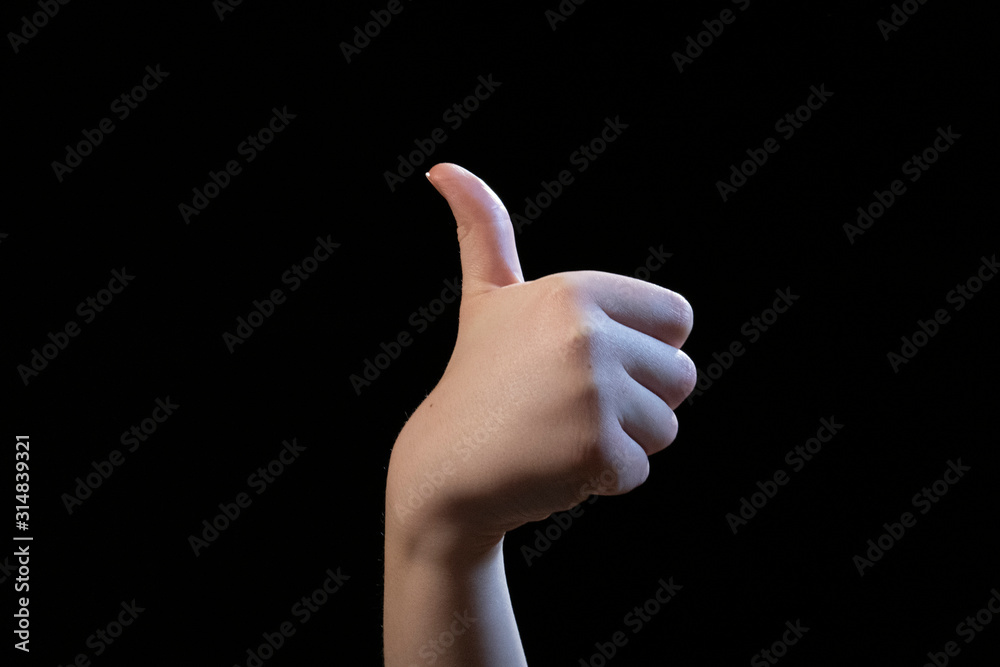 hand with thumb up isolated on black background