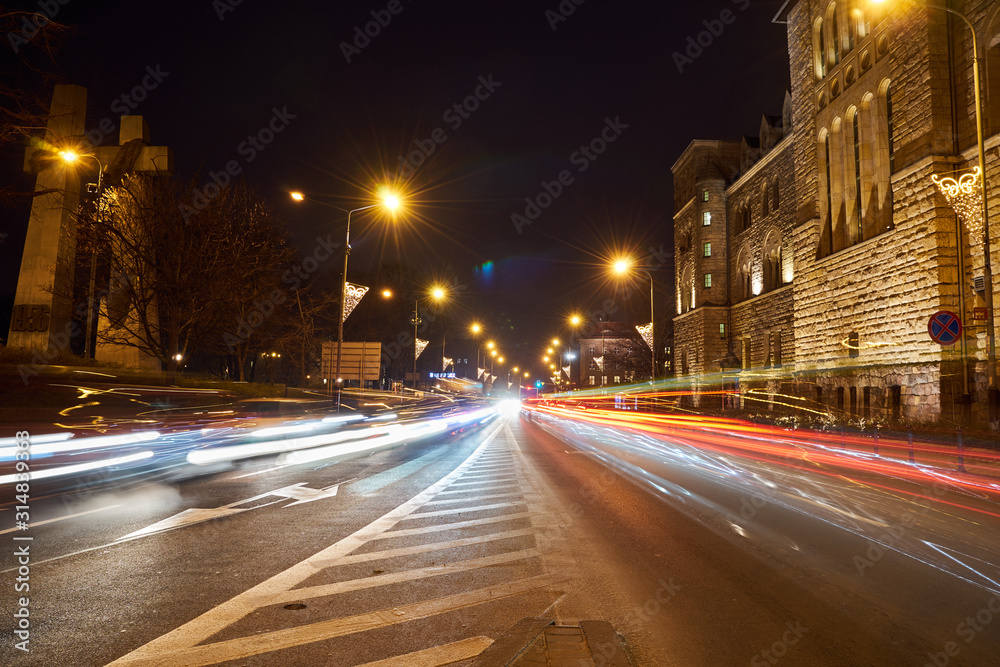 Street and car traffic during the night in Poznan..