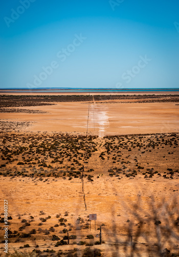 Overlooking vast bush desert with ocean in horizon in western australia