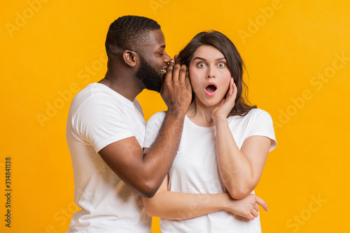 African American Man Sharing Secret With His Shocked Girfriend