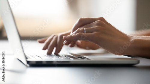 Close up of woman typing message on keyboard
