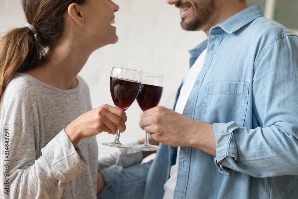 Close up focus on two clinking glasses of wine. Close up focus on two clinking glasses of wine.