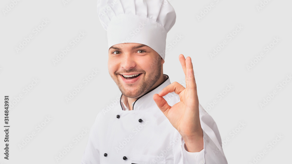 Confident Chef Man Gesturing Okay Approving Recipe, White Background Confident Chef Man Gesturing Okay Approving Recipe, White Background