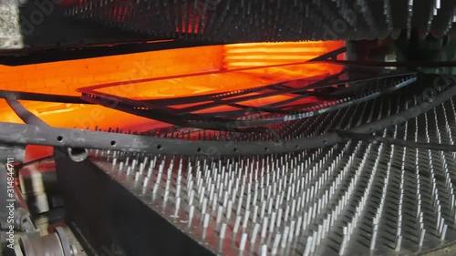 Annealed glass in a furnace.A glass factory.Cart with glass goes into the oven.