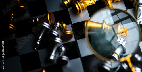 business strategy solution ideas concept chess board figure with magnifying glass color tone close up chess and magnifying glass dark tone
