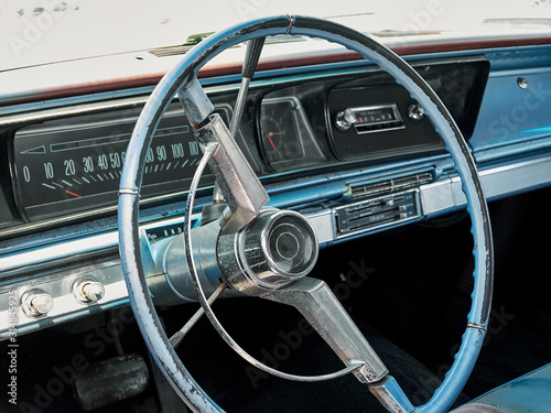 Steering wheel and panel with dashboard in interior of old retro american car © Владислав Винокуров