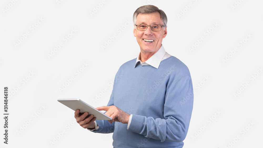 Smiling Elderly Man Using Digital Tablet Standing, Studio Shot, Panorama Smiling Elderly Man Using Digital Tablet Standing, Studio Shot, Panorama