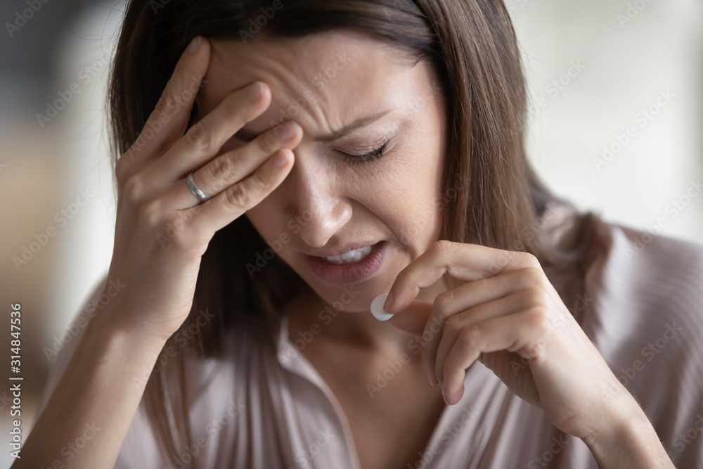 Sick woman suffer from headache taking pill Sick woman suffer from headache taking pill