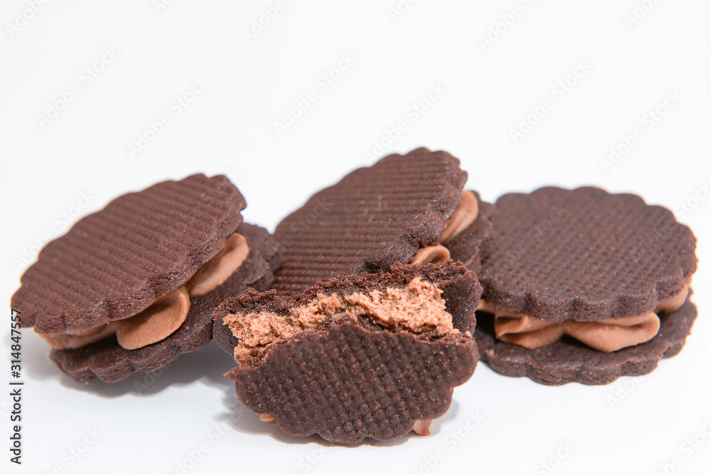 sandwich brown biscuits with brown cream on white background sandwich brown biscuits with brown cream on white background