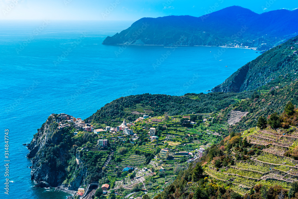 Cinque Terre coastal area around Corniglia Village as seen from the trail, the Cape Punta Mesco is at background. Liguria, Italy.