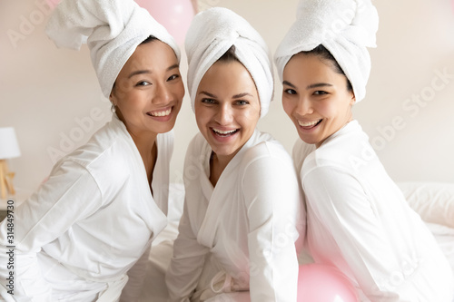 Fototapeta Portrait of multiracial girls in bathrobes celebrating bridal shower