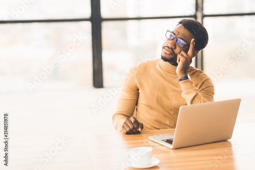 Fotografia Exhausted african american manager feeling sad and desperate