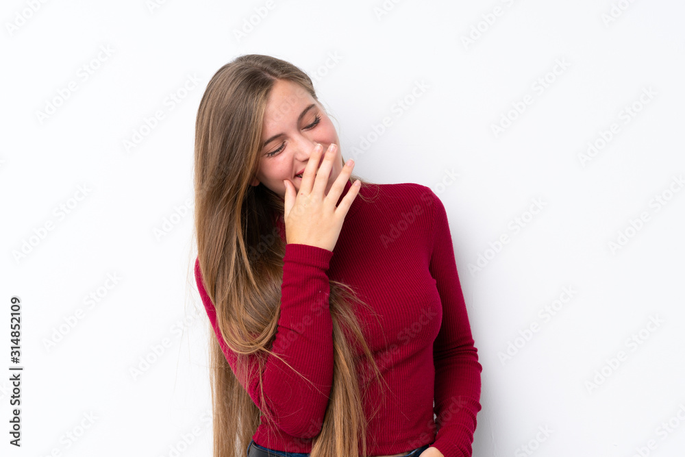 Teenager blonde girl over isolated white background smiling a lot Teenager blonde girl over isolated white background smiling a lot