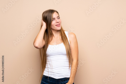 Teenager blonde girl over isolated background thinking an idea