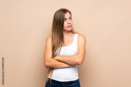 Teenager blonde girl over isolated background portrait