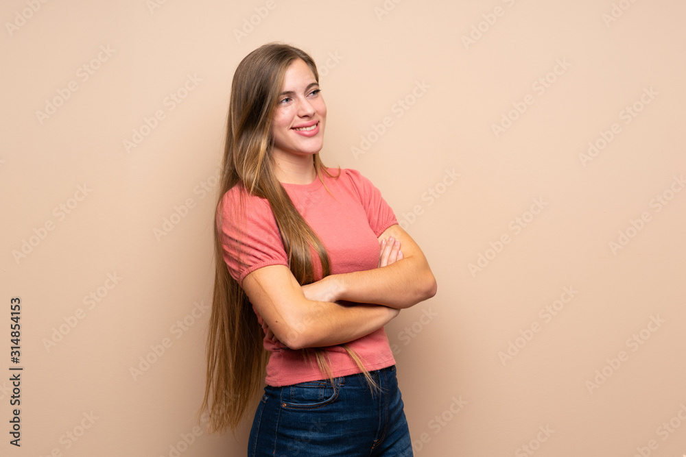 Teenager blonde girl over isolated background looking to the side Teenager blonde girl over isolated background looking to the side