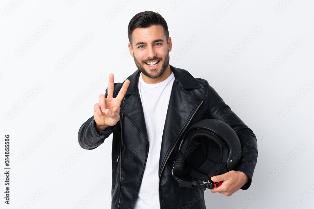 Man with a motorcycle helmet smiling and showing victory sign Man with a motorcycle helmet smiling and showing victory sign