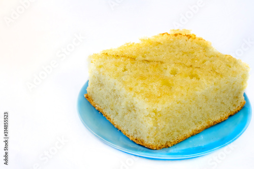 magnificent sponge cake on a white plate and a blue plate