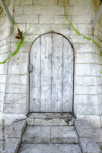 Old wooden door with stone wall