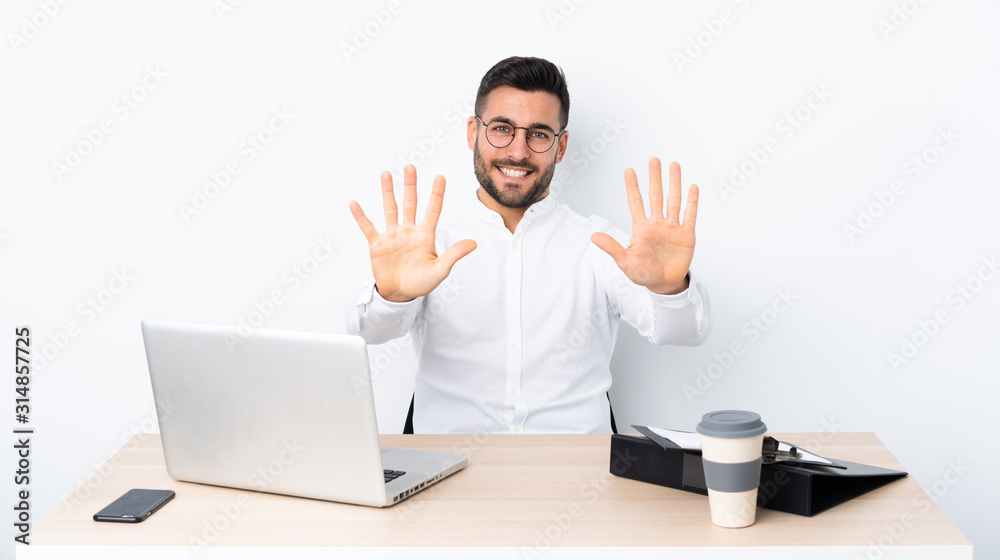 Young businessman in a workplace counting ten with fingers Young businessman in a workplace counting ten with fingers