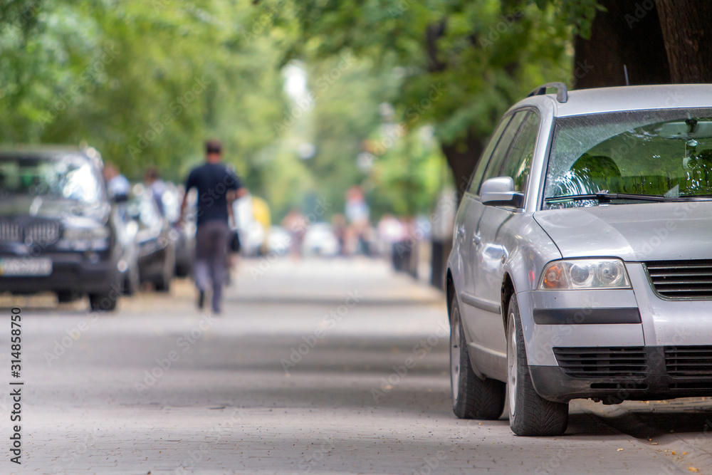 A car parked near curb on the side of the street on a parking lot.