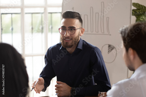 Confident Arabic businessman hold team meeting with employees