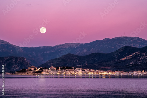 Full moon rising over St Florent in Corsica photo